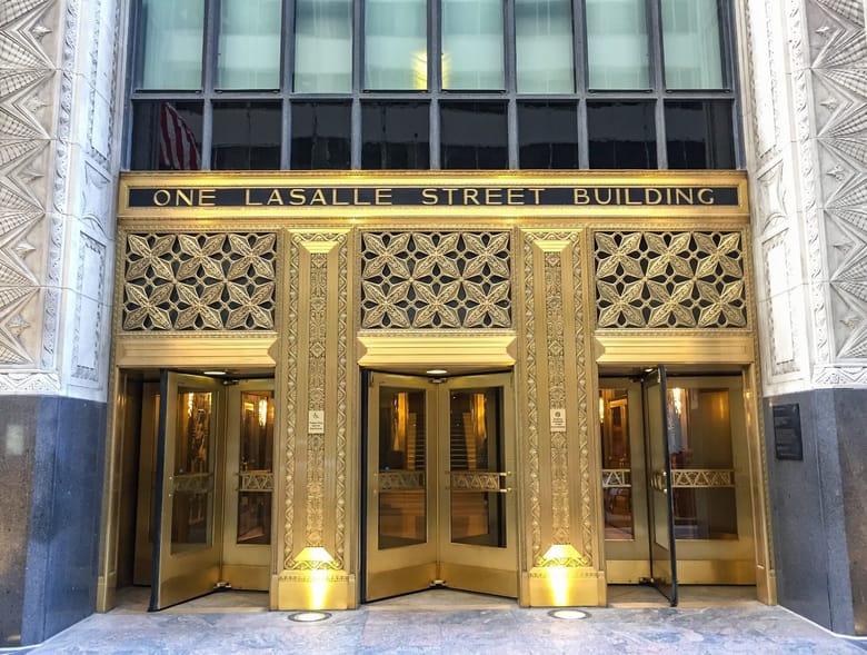 Exterior shot of gold doors of a skyscraper