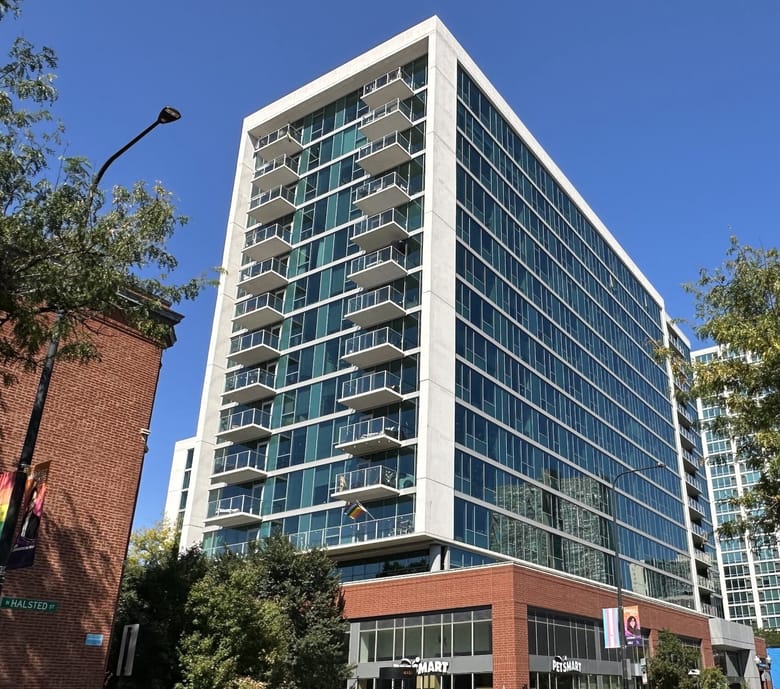 A glass building with balconies.